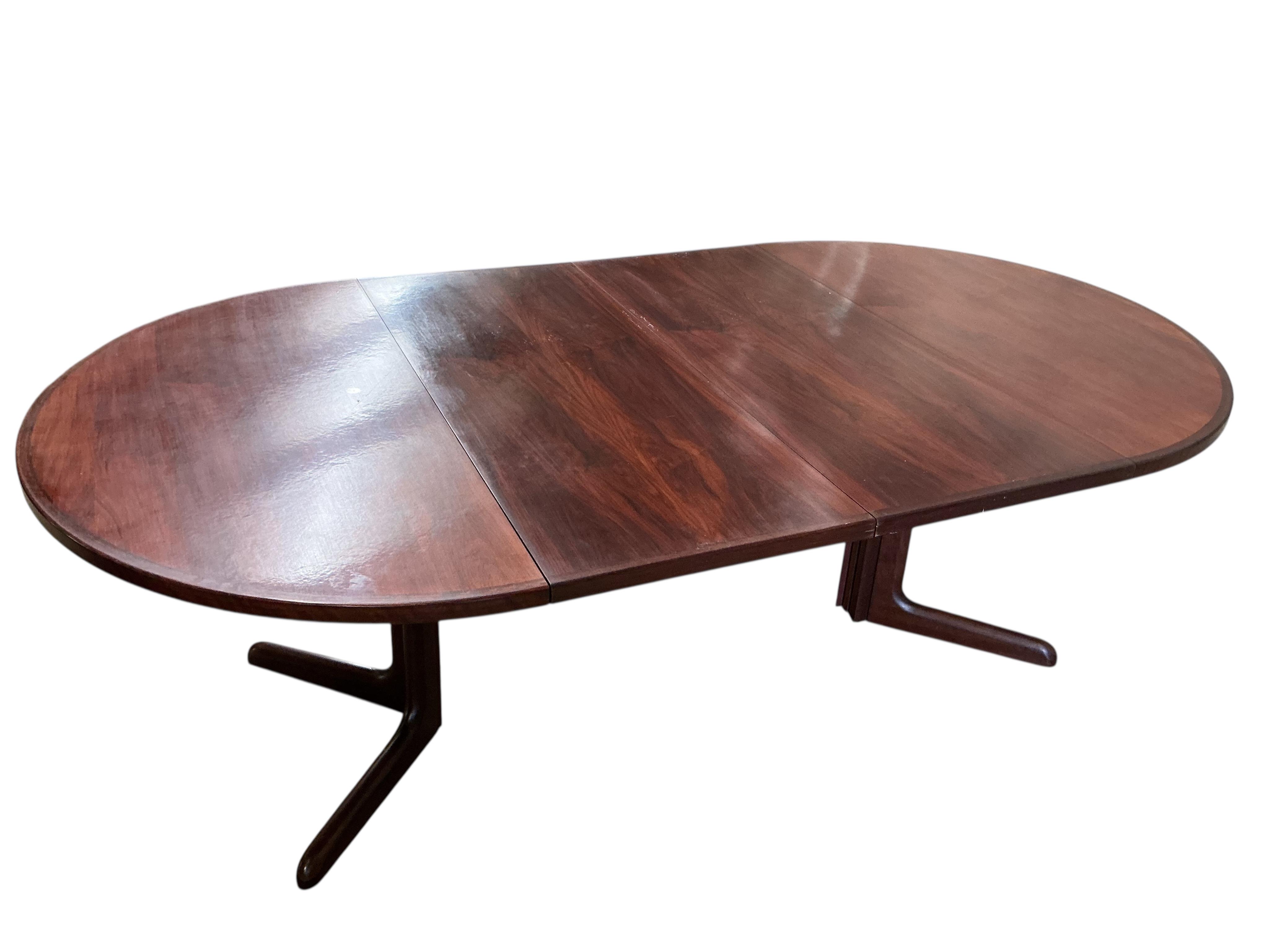 Niels Otto Møller (Danish, 1920-1982) for Gudme Mobelfabrik, a mid century Indian rosewood circular extending dining table, 218cm extended, two spare leaves, height 72cm